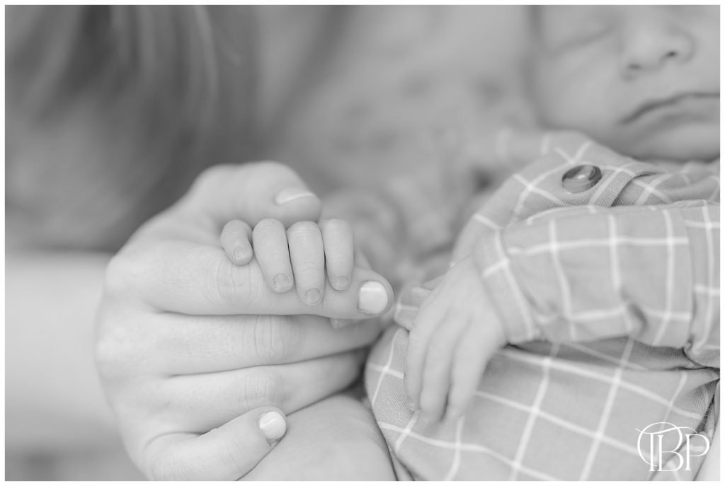 Mom and baby holding hands during Leesburg, VA at home newborn photos