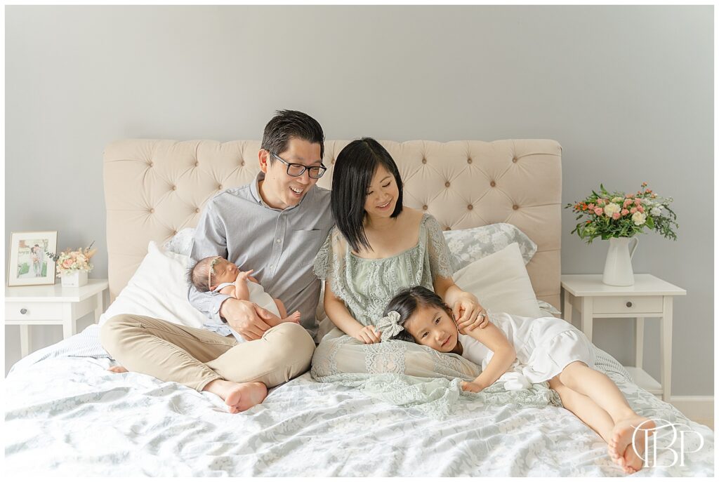 Family of 4 in bedroom during Warrenton, VA at home newborn photography