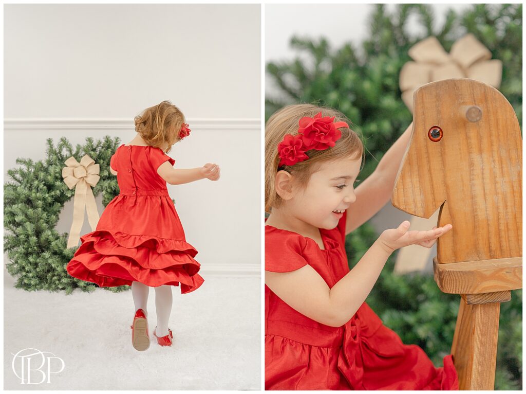 Girl feeding the wooden horse taken by a Northern VA studio Christmas mini photographer
