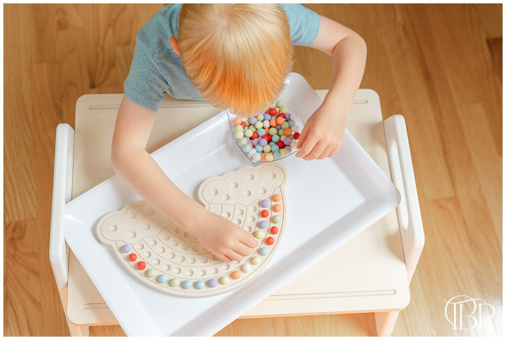 Boy playing with activity board during product photoshoot