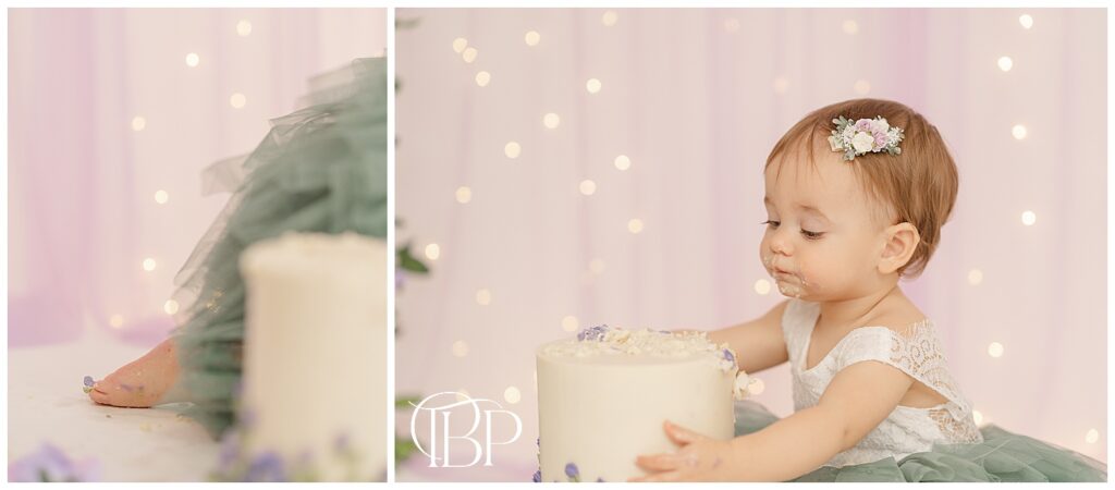 Baby holding her cake