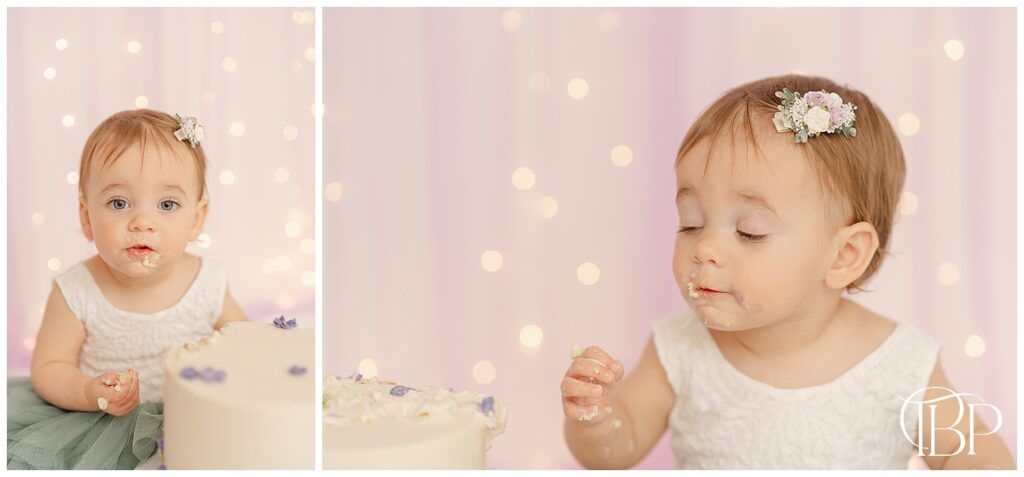 Baby girl eating cake while her eyes are closed