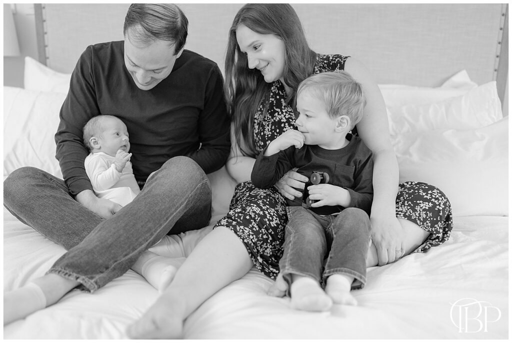 Family looking at baby during Oakton, VA at home newborn session