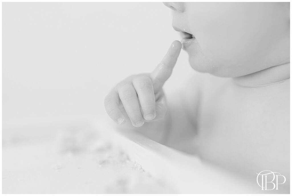 Baby's hand during Ashburn, VA studio simple cake smash photoshoot