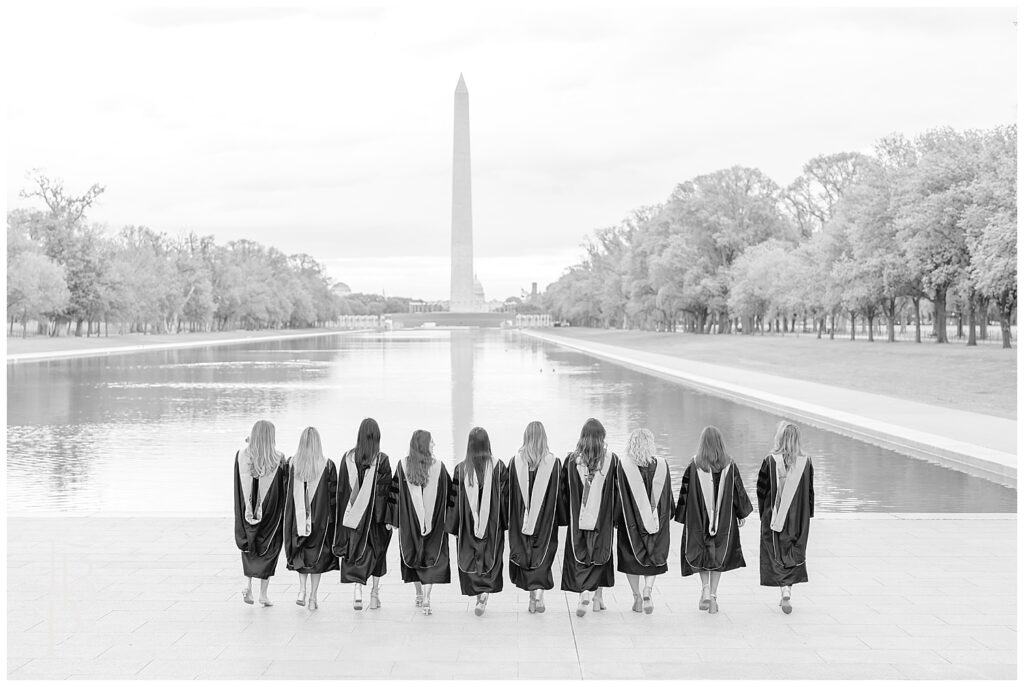 Friends wearing graduation gown walking