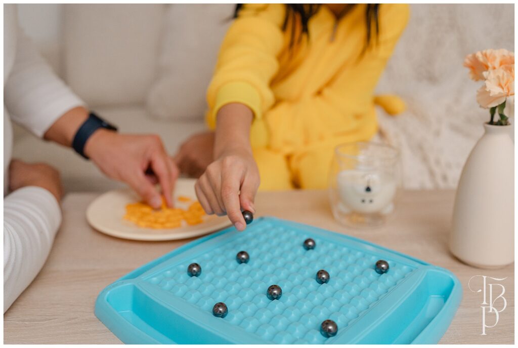 Parent & kid playing magnetic chess board