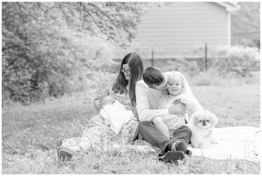 Family interacting during outdoor newborn session