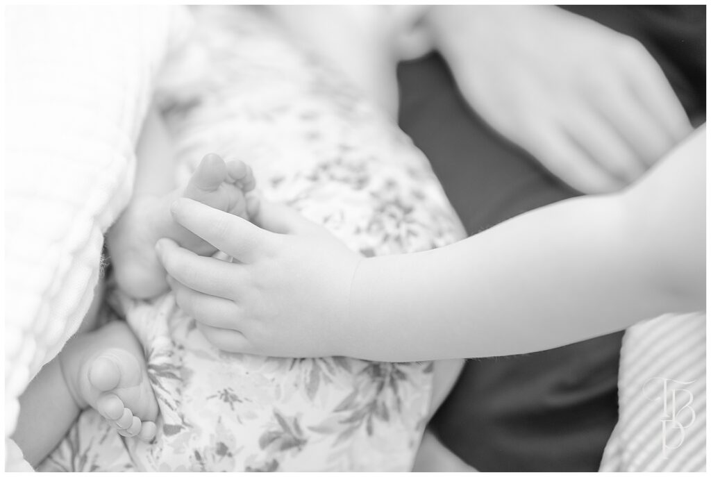 Sister holding baby's foot during Ashburn,Virginia