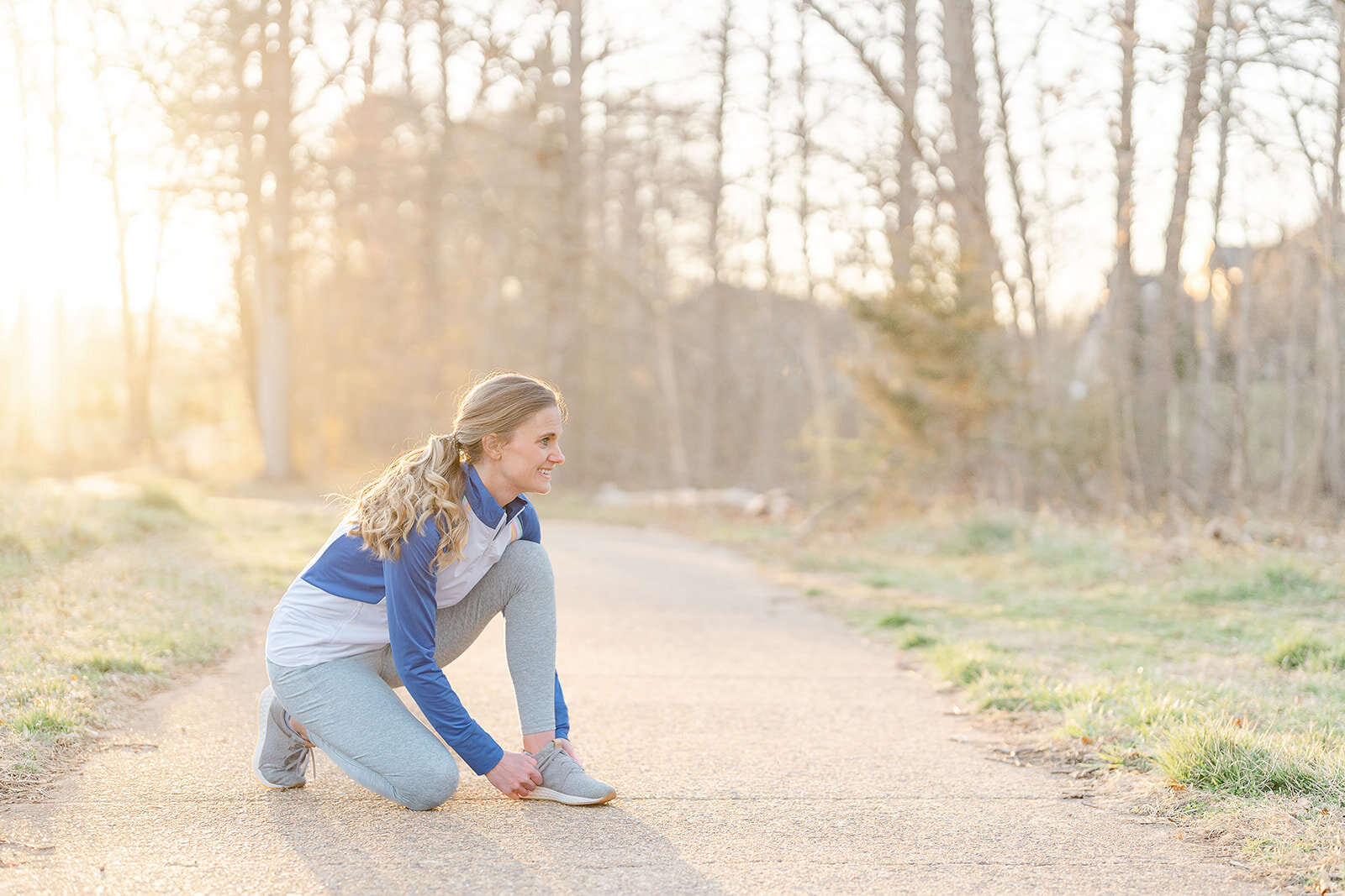 woman tying her shoes during brand photos and why you need them updated