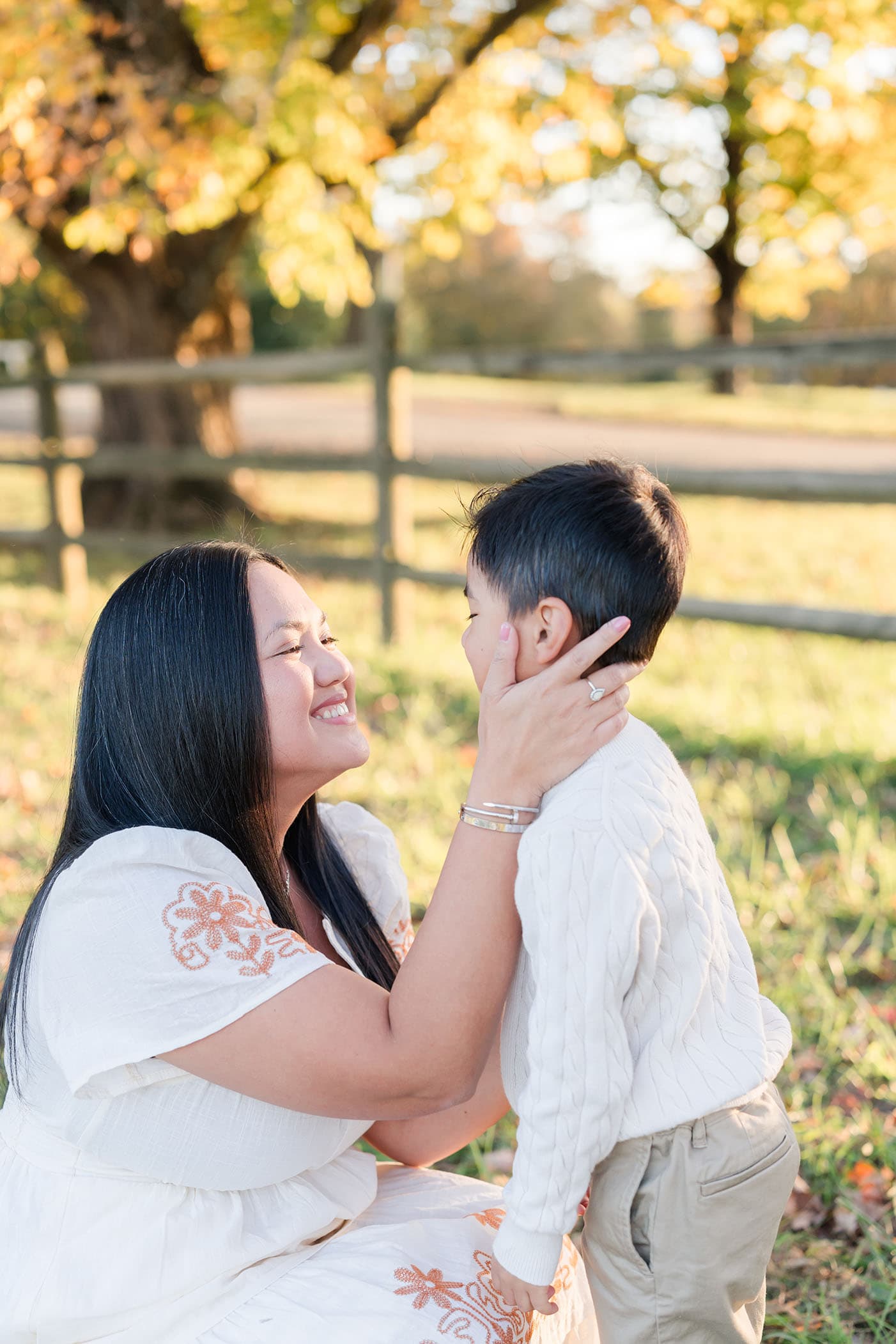 mom holding son's cheeks, looking at him lovingly