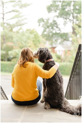 Business owner sitting on steps with her dog