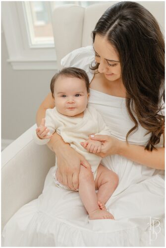 Mother holding her newborn during lifestyle family photography