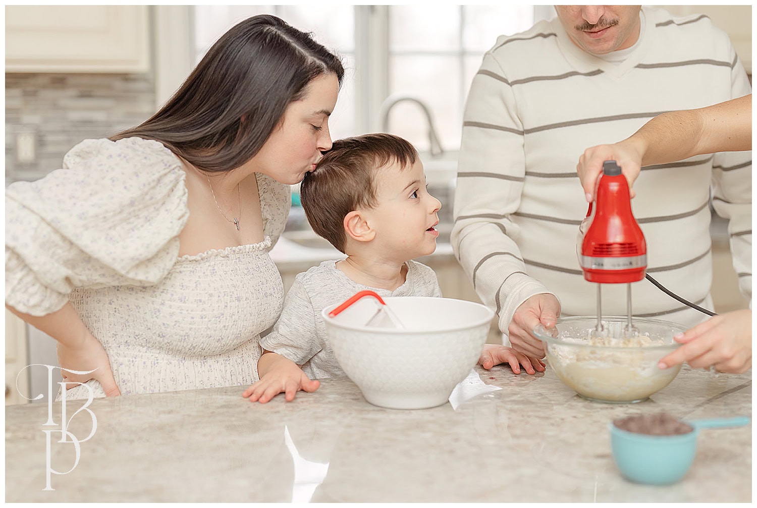 Sister kisses brother during lifestyle family photos at home