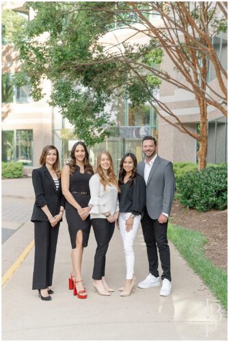Team brand photo of business professionals standing outside office building