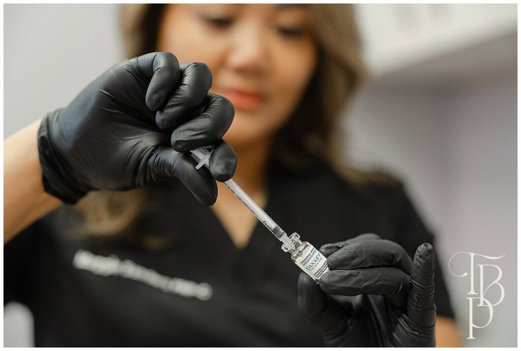 woman holding a syringe and a bottle during, a sample brand picture