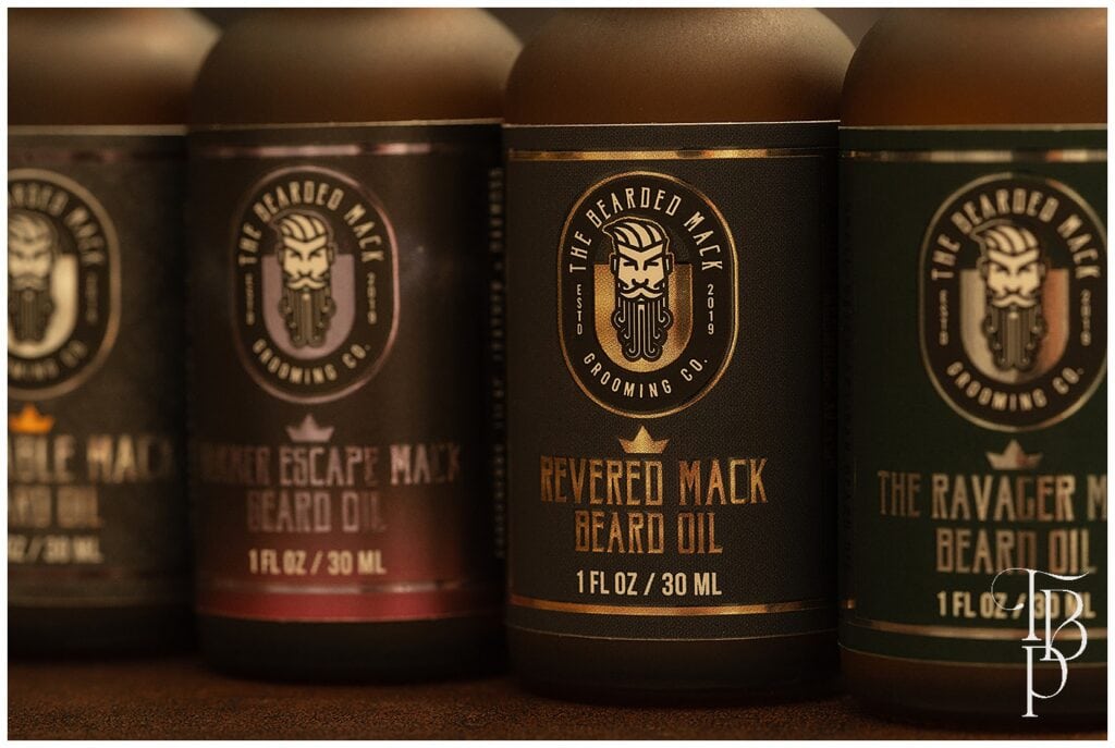 Close-up of beard oil bottles showcasing a company's branding and packaging design